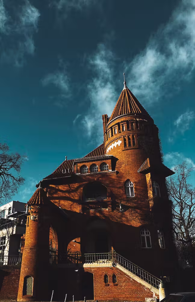 Red-brick tower against a teal sky