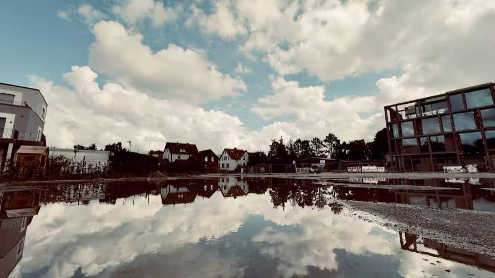 Clouds reflected in a puddle