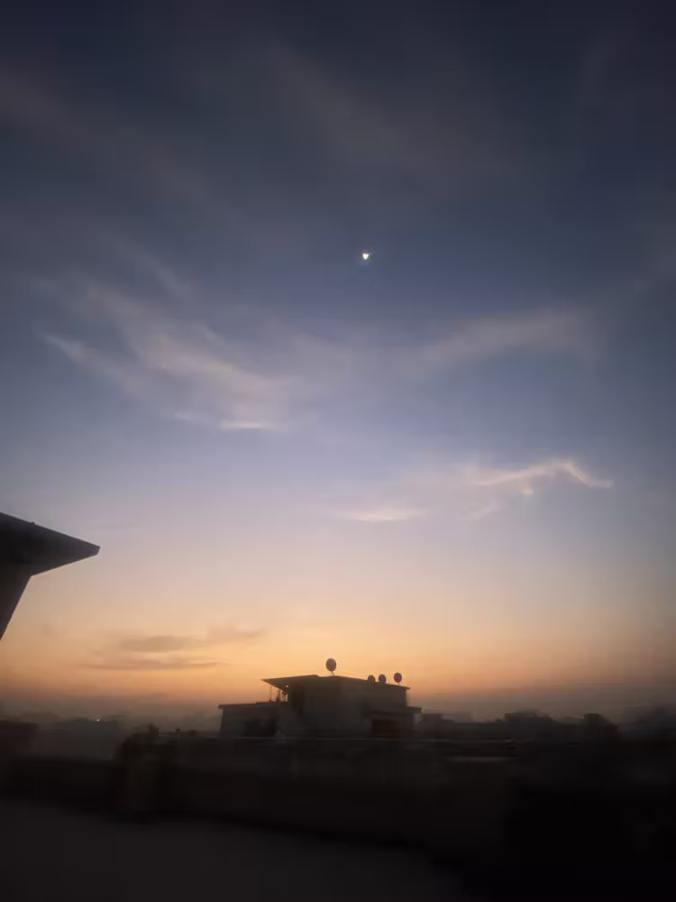 Dawn over the rooftops, with the morning star still out