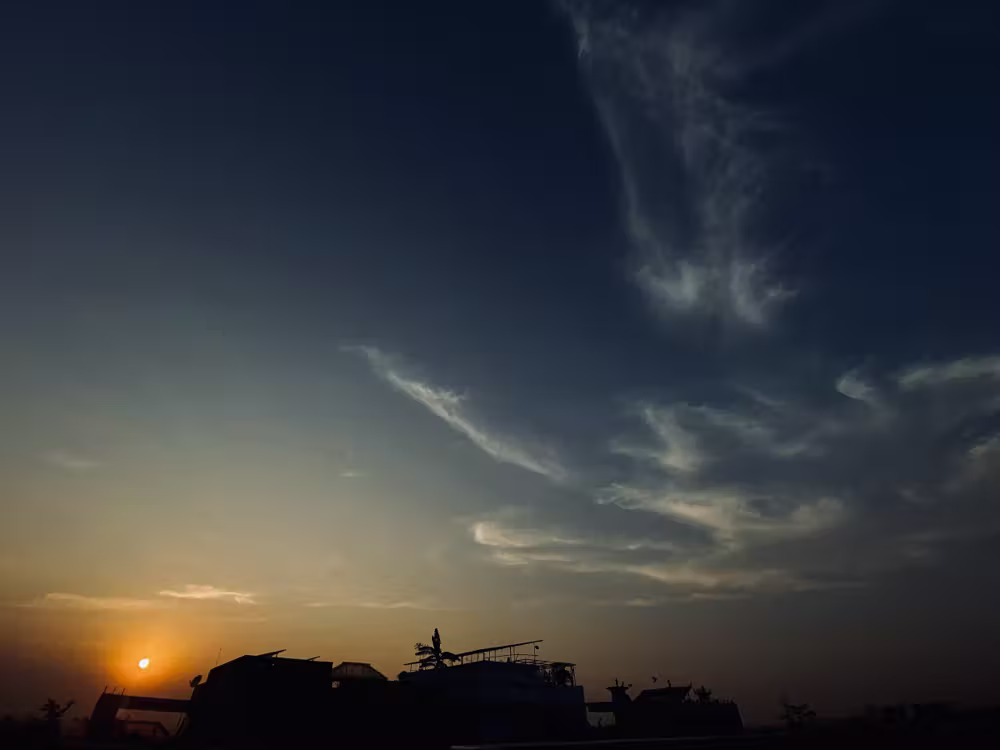 Sunset and wispy clouds over the rooftops