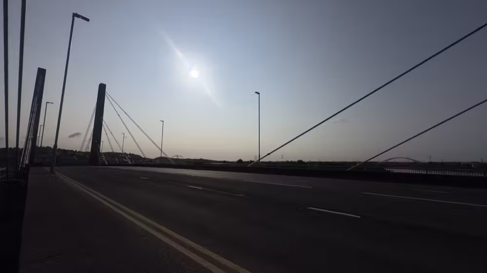 Bridge in silhouette against the sun