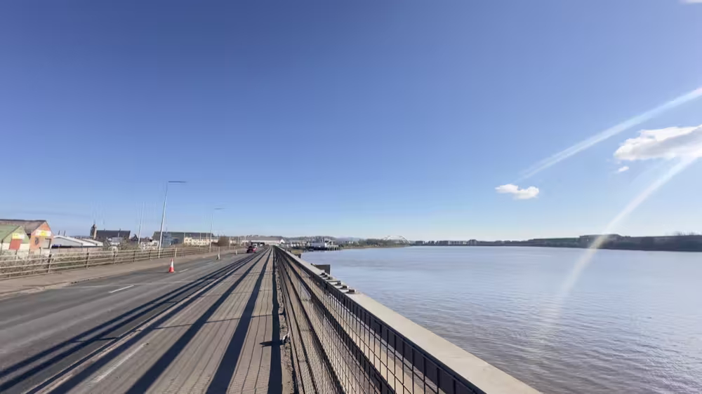 Railings along the river on a clear day