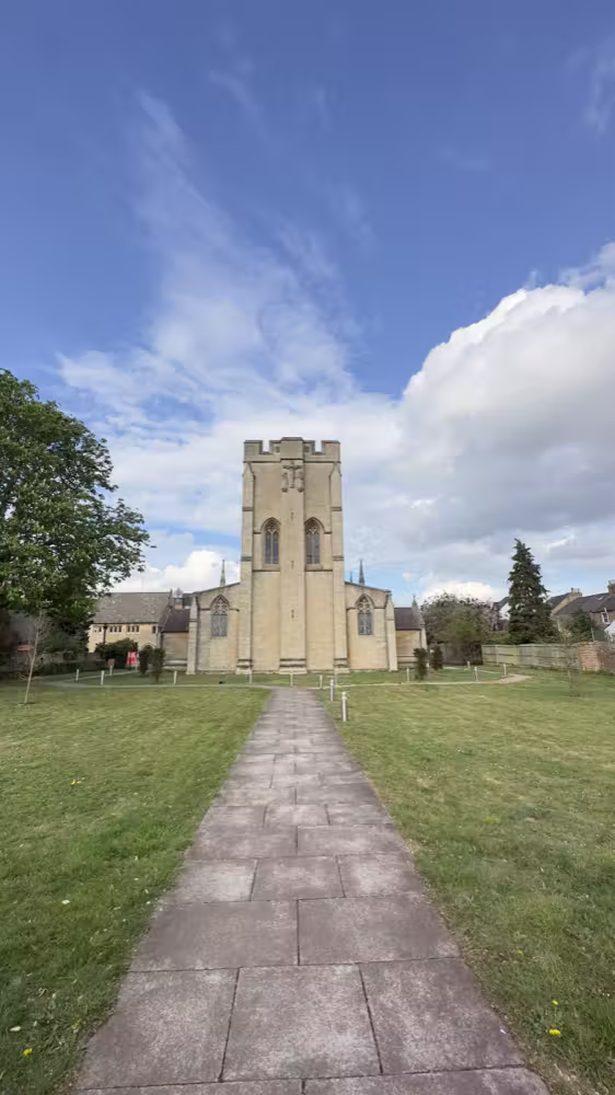 Path to a church under a cloudy sky