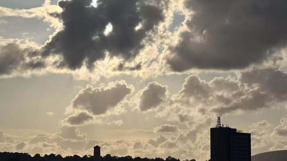 Clouds over a tower in silhouette