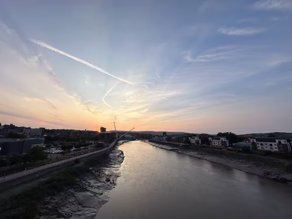 Sunset and contrails over the river