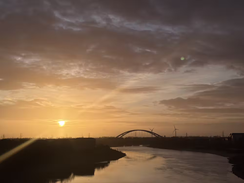 Sunset over the river and the arch bridge